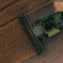 Tractor from above harvesting crops