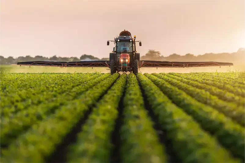 Tractor-spraying-pesticides-on-soybean-field-with-sprayer-at-spring