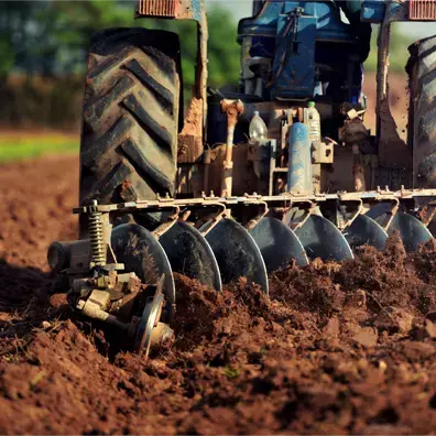 Tractor tilling soil